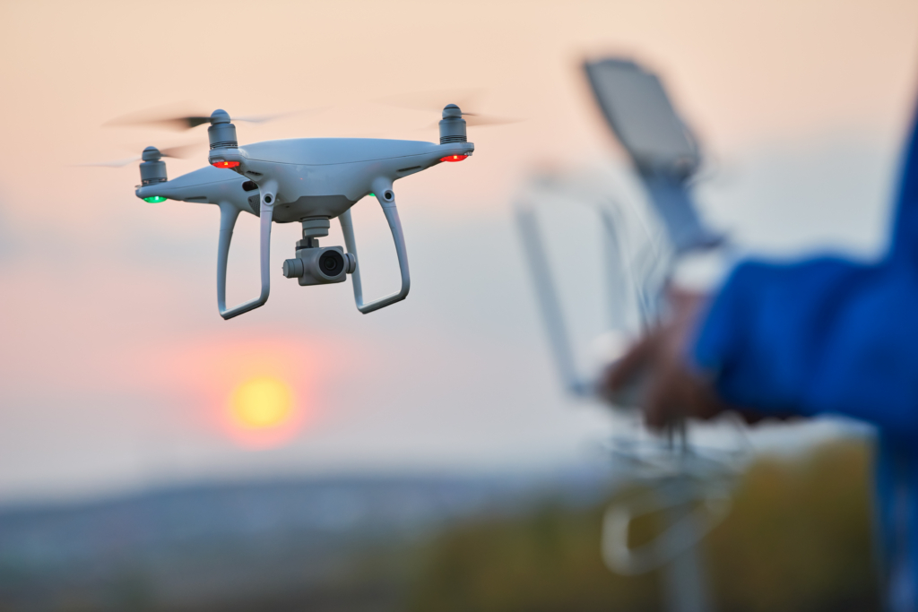 A drone flying near an airport with a passenger aircraft in the background